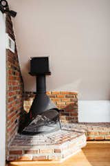 A closer look at the original, wood-burning fireplace and brick hearth.