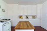 Another view of the kitchen shows cabinetry that lines the rear wall.