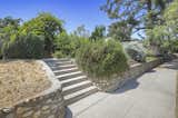 Located within a city preservation zone, the property’s front lawn is bordered by a landmarked Arroyo Stone retaining wall that also runs in front of several neighboring houses.