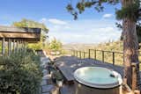 Another view of the deck shows off the hot tub in one corner.  Photo 16 of 17 in A Refined Midcentury Home on a Los Angeles Hilltop Lists for $2M
