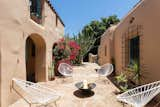 The paved courtyard is nearly 1,000 square feet, complete with archways and an adobe brick wall that encloses the rear of the space.