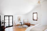 Upstairs, a private bedroom with en suite bathroom fills the second floor above the kitchen. Here, the sleeping area features a stained glass window at one end.  Photo 9 of 20 in The Restored L.A. Home of Poet Alice Lynch Is a Rad Option If Your Budget Stretches to $1.8M