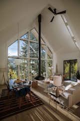 At Alex Strohl and Andrea Dabene’s Nooq House in the Rocky Mountains of northwest Montana, highlights include a suspended fireplace, cathedral ceilings, and expansive windows. "The windows are my favorite feature. I've loved seeing the colors change in the fall, snow in the winter, and bears in the spring," says Andrea.