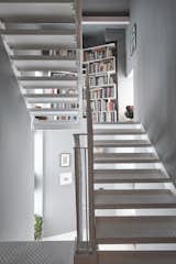 A closer look at the original steel staircase, which Heron refinished during the conversion. Stairs leads down to the main entrance and up to the bedroom/bathroom.  Photo 6 of 11 in A Penthouse Apartment in a London Water Tank Offers Utilitarian Style for $781K