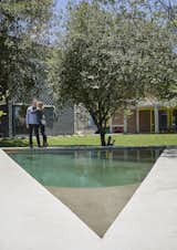 With the house and studio in the background, Greg and Caryn admire the architect’s handiwork. One of a handful of pleasurable amenities distributed across the site, the eccentric triangular-shaped swimming pool wedges itself comfortably into the northeastern corner of the property. The fact that it’s raised means that the pool itself creates its own protective edge, dispensing with the need for a traditional pool fence.