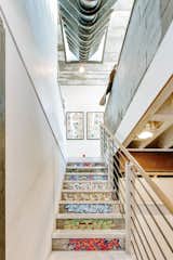 Another staircase leads down to the basement.  Photo 19 of 22 in An Arty Couple Say Goodbye to Their Handcrafted, Net-Zero Shipping Container House for $3.15M