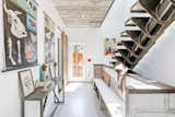 Another view of the entryway and another side door. The couple refer to the industrial-style staircase as "the whale spine."  Photo 4 of 22 in An Arty Couple Say Goodbye to Their Handcrafted, Net-Zero Shipping Container House for $3.15M