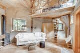 The adjacent studio has a similar aesthetic as the cob house, with an abundance of natural materials and finishes. A handcrafted ladder provides access to a bedroom loft.&nbsp;