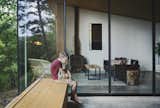 Running along the open side of the porch is a built-in wood bench that doubles as a security barrier.