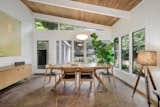 The dining area features flagstone floors, as well as a door that leads out to a Zen-like garden. The wood ceilings and walls are original to the home, and they were refinished during the renovation.