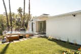 After, a white paint job, new landscaping and fixtures, as well as the addition of several glass doors give the facade a new look.  Photo 4 of 25 in Before & After: Two Brothers List Their Swanky Midcentury Bachelor Pad for $1.6M
