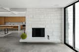 Today, the white-painted stone fireplace falls in line with the overall aesthetic.