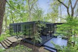 Originally the home of a local architect, this steel-and-glass home is now up for sale in Downers Grove, Illinois. The structure is sited toward the back of a mostly wooded .34-acre lot, with a dense section of trees providing additional privacy from the street.
