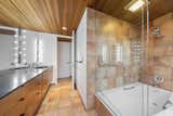 The attached bathroom offers a double vanity and large tub/shower.