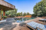 A large deck surrounds the pool at the bottom of the lot.  Photo 21 of 24 in Asking $3.75M, This Bohemian Hillside Home in L.A. Comes Complete With a Potter’s Studio