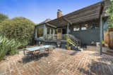 A rear patio is accessible from the living room and kitchen.  Photo 17 of 24 in Asking $3.75M, This Bohemian Hillside Home in L.A. Comes Complete With a Potter’s Studio