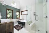 The master bathroom features a clawfoot tub, custom vanity, and glass-walled shower. A skylight illuminates the space from above.  Photo 10 of 24 in Asking $3.75M, This Bohemian Hillside Home in L.A. Comes Complete With a Potter’s Studio