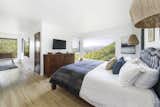 In the master bedroom, a large picture window frames a view of the surrounding hills.  Photo 8 of 24 in Asking $3.75M, This Bohemian Hillside Home in L.A. Comes Complete With a Potter’s Studio