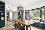 Back near the main entrance, another dining area features built-in seating along a bay window. Additional built-in cabinetry flank both sides of the doorway.  Photo 5 of 24 in Asking $3.75M, This Bohemian Hillside Home in L.A. Comes Complete With a Potter’s Studio