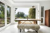 French doors lead out to a porch and down to the poolside patios.  Photo 4 of 24 in Asking $3.75M, This Bohemian Hillside Home in L.A. Comes Complete With a Potter’s Studio