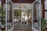 French doors in the living area lead out to a cozy outdoor space.