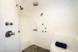 One of the home's six full bathrooms comes with an igloo–like shower area complete with stone flooring.