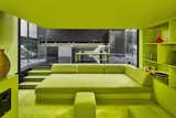 The living room retains Adjaye’s original lime-green color scheme, and also features a built-in projector and surround sound.