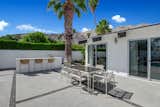 The patio also offers a built-in grill and bar, as well as numerous areas for lounging and entertaining. Nearly two-thirds of the .23-acre lot is enclosed to provide greater privacy.  Photo 10 of 17 in A Palm Springs Alexander Home Sings After a Chic Renovation and Hits the Market to the Tune of $2.1M