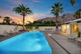 Once the sun goes down, the backyard pool glistens alongside an adjacent fire pit and spa.  Photo 16 of 17 in A Palm Springs Alexander Home Sings After a Chic Renovation and Hits the Market to the Tune of $2.1M