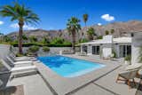 Outside, a sparkling pool and sunny patio await.  Photo 9 of 17 in A Palm Springs Alexander Home Sings After a Chic Renovation and Hits the Market to the Tune of $2.1M