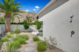An outdoor shower is located around from the pool.  Photo 11 of 17 in A Palm Springs Alexander Home Sings After a Chic Renovation and Hits the Market to the Tune of $2.1M