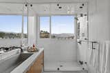 The en suite bathroom features a large shower with framed views of the&nbsp;Franklin Hills and San Gabriel Mountains.