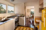 The penthouse's recently remodeled kitchen features updated appliances and finishes, mixed with original features such as a built-in banquette.