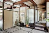 Back in the entryway, a Japanese-style Shoji screen delineates between public and private spaces by separating a hallway that leads to the home's bedrooms.