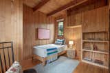 Wood dominates the interior of the cottage, which features several built-ins and a leaded glass window.