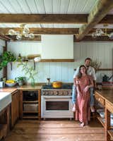 After combing through kitchen cabinets and finding nothing appealing that would fit their budget, Danielle and Ely decided to build everything themselves with lumber from the hardware store—sanding, staining, and sealing each piece. The countertops are plywood, as is the range hood surround.