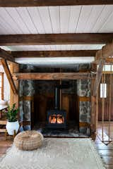 An indoor swing adds a whimsical touch to the stone hearth and wood-burning stove just off the dining area.