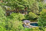 The lush landscaping hides an in-ground saltwater pool and a bluestone patio.