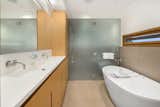 The adjacent bathroom offers a double vanity, large shower, and soaking tub.