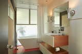 One of the home’s three bathrooms features a soaking tub and original jalousie&nbsp;windows.