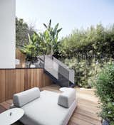 Outside, a bi-level rear deck is clad in Western Red Cedar and surrounded by lush plantings.