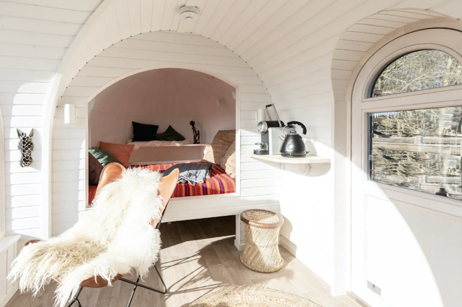 Inside, an alcove to one side contains a bed with luggage storage underneath.