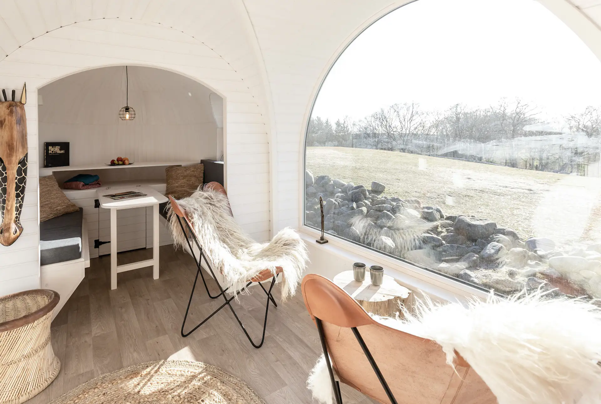 On the opposite side, a dining alcove doubles as an additional sleeping area if needed.