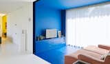 Here, the TV room is painted in a vivid blue, adding a bold pop of color during the daytime and transitioning into a calming space for relaxing at night.