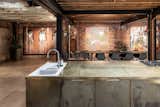 The long kitchen island was custom made and inspired by the design of a welder’s bench.  Photo 3 of 15 in This Live/Work Warehouse That Starred in Steven Spielberg’s “Ready Player One” Lists for £2.75M