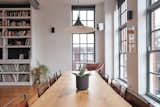 Dining Room, Chair, Medium Hardwood Floor, Table, and Pendant Lighting Another view of the dining area overlooking the building's inner courtyard.  Photo 6 of 13 in For £1.2M, Snag This Spacious London Flat Inside a Converted Victorian Schoolhouse