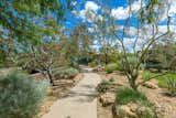 Concrete paths wind throughout the property, past plantings of native species such as rubber rabbitbush, big galleta grass, Mormon tea, Apache plume, and many other varieties.
