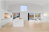 Sliding glass doors in the kitchen and dining area lead to the rear patio and driveway.  Photo 5 of 10 in Bjarke Ingels’s Hobbit-Esque Hill House Lists for $715K