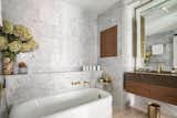 The en-suite bathroom features a cast iron soaking tub and&nbsp;Vola fixtures.