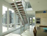 With a minimalist and airy design, floating stair designs like this one are supported by a central steel stringer to which each tread is mounted. The FLIGHT Floating Stairs System by Viewrail is a made-to-order solution that arrives at the job site as a prefabricated kit—including pre-drilled, ready-to-assemble components for both the stairway and railings.